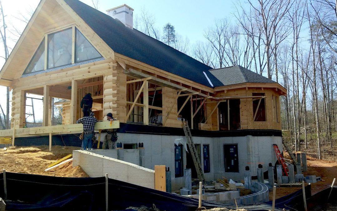 Photo of round log facade log home under construction